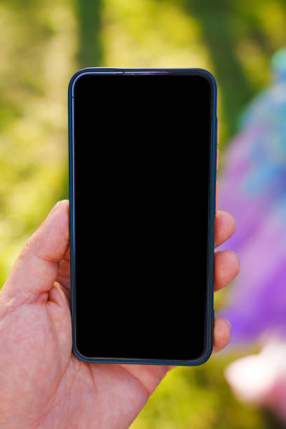 istock A smartphone in a man's hand with a blank black screen. 2171657460