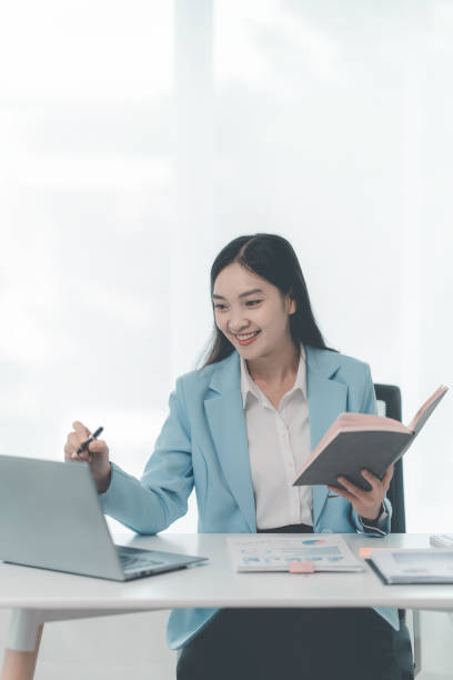 istock Financial professionals and analysts work with documents and calculators to calculate financial reports in their home offices. 2171657787