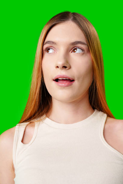 istock Young Woman With Surprised Expression in Front of Green Screen 2171657886