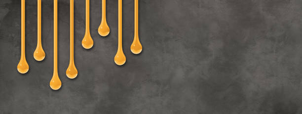 istock Yellow ink drops on dark concrete wall. Horizontal banner 2171658560