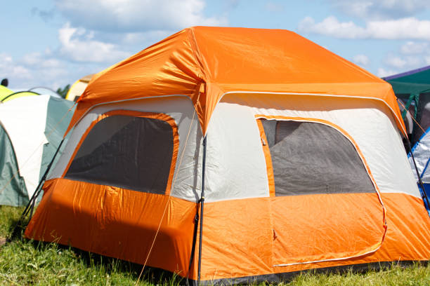 Tourist tents stand outdoors in summer.