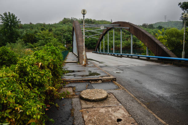 istock arched bridge over wet road on a rainy day 2171659295