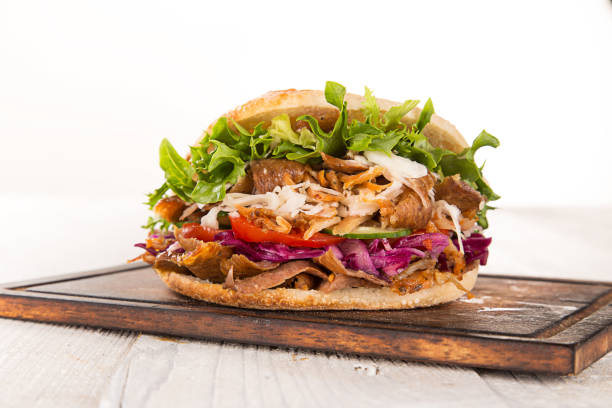 process of preparing traditional Turkish fast food  grilled meat or shawarma or kebab. chef hand cooking food