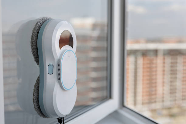 istock Automatic vacuum robot window cleaner washes glass in the apartment, balcony frame. 2171661083
