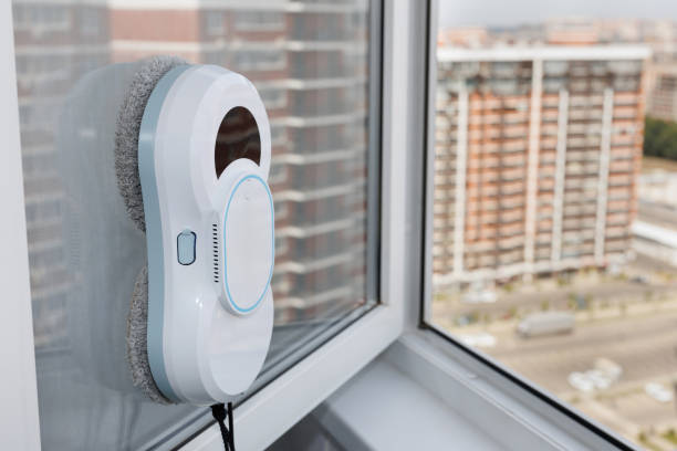 istock Automatic vacuum robot window cleaner washes glass in the apartment, balcony frame. 2171661236