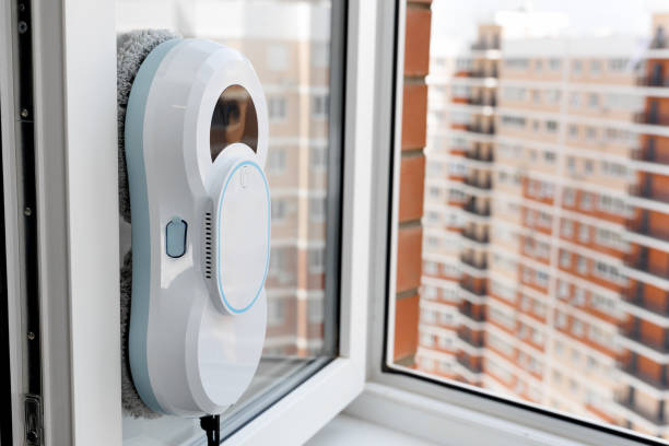 istock Automatic vacuum robot window cleaner washes glass in the apartment, balcony frame. 2171661543