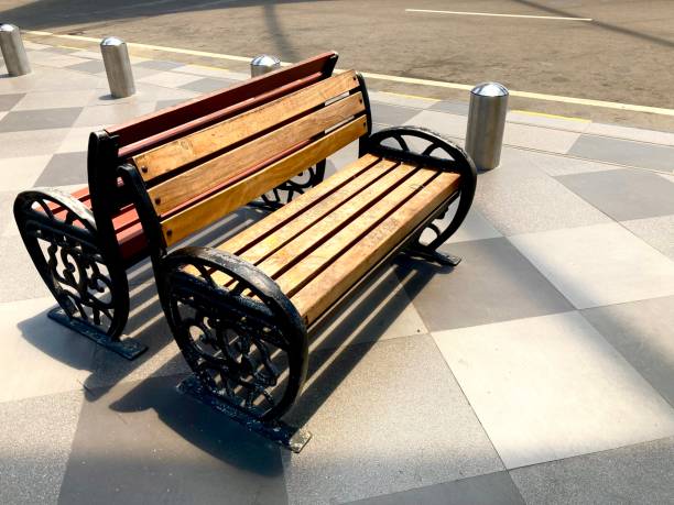 istock empty wooden seat on a sidewalk with sunlight 2171662100