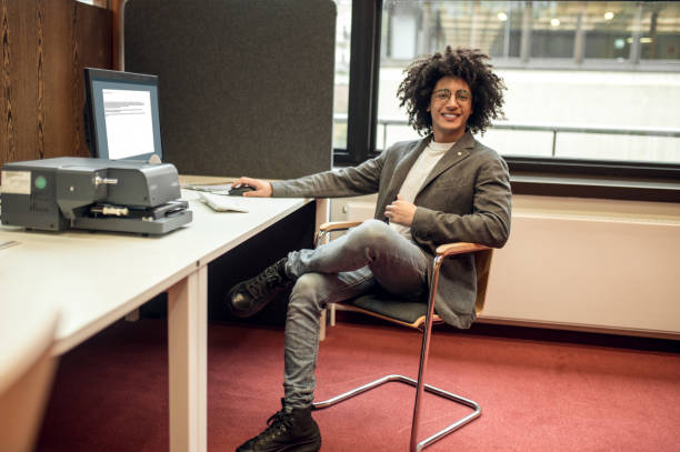 istock Young curly-haired businessman in the office looking confident 2171664000