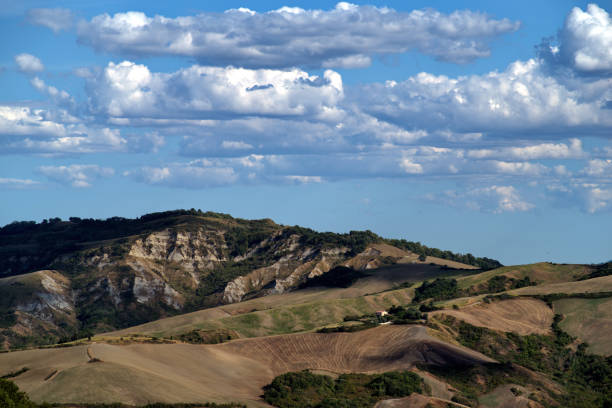 Autumn hilly panorama against partly cloudy sky in Montefeltro