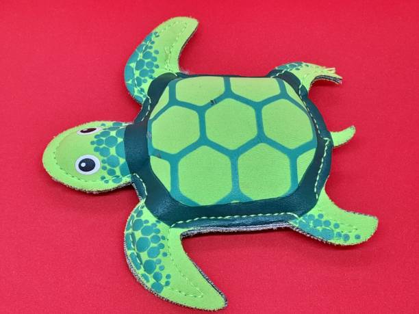 istock Green turtle figure with red background 2171667208