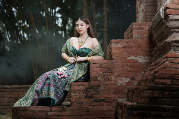 Young Asia woman in Thai dress traditional in the old temple background  at Ayutthaya Thailand.