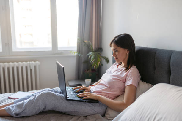 istock Young Woman Working On The Laptop From Her Bed 2171669832