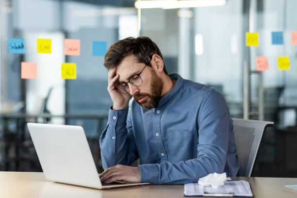 istock Stressed office worker sitting at desk with laptop feeling burnout 2171670395
