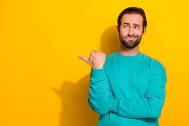 istock Photo of funny look empty space suspicious grimace student guy wear blue pullover distrust media tv news politics isolated on yellow color background 2171672149