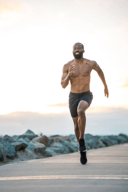 istock Fit Black Man Running by the Ocean 2171672617