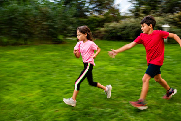 Children playing catch in a grass garden