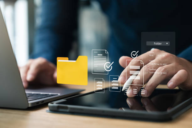 istock Document management system, DMS, company employees manage folders via laptop. 2171675137