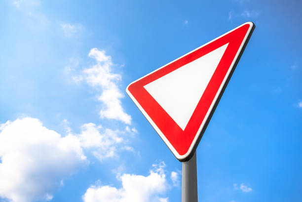 Yield Right-of-Way. This sign indicates driver must yield to traffic on the upcoming priority road. If necessary, come to a complete stop to allow traffic on the priority road to clear before proceeding.