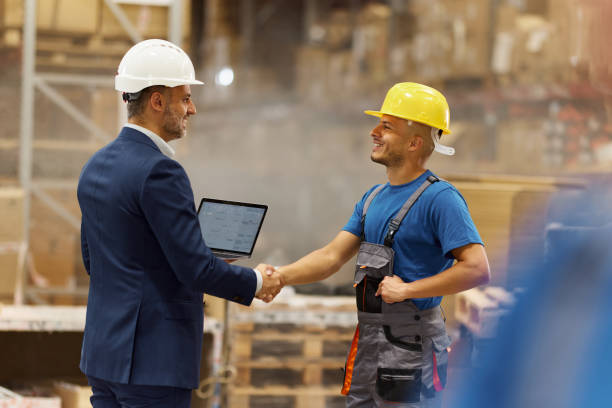 istock Happy inspector greeting with manual worker in storage room. 2171676302