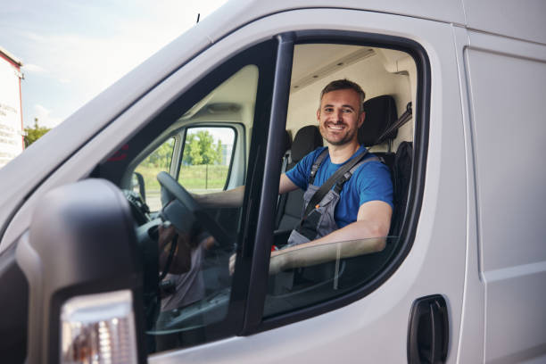 istock Happy delivery man driving a van. 2171676507