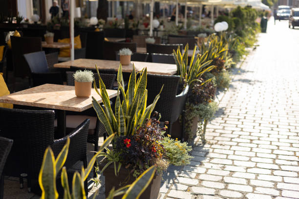 Empty restaurant summer terrace with tables and chairs. Restaurant tables waiting for customers at an outdoor terrace