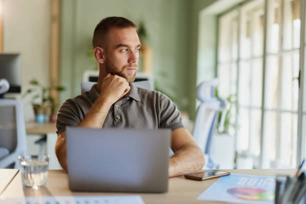 istock Thoughtful creative man working on laptop in the office. 2171680241