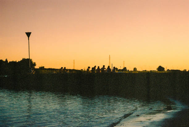 People looking at the sunset at the Rhine River