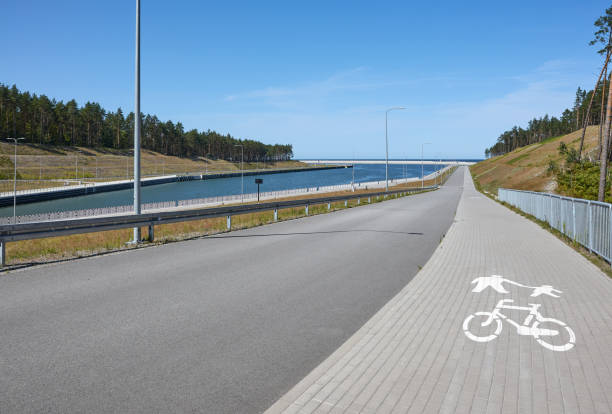 istock Bike path shared with sidewalk along asphalt road. 2171680779