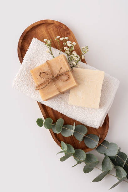 istock Folded soft white terry towel with soap bar on a wooden tray 2171681926
