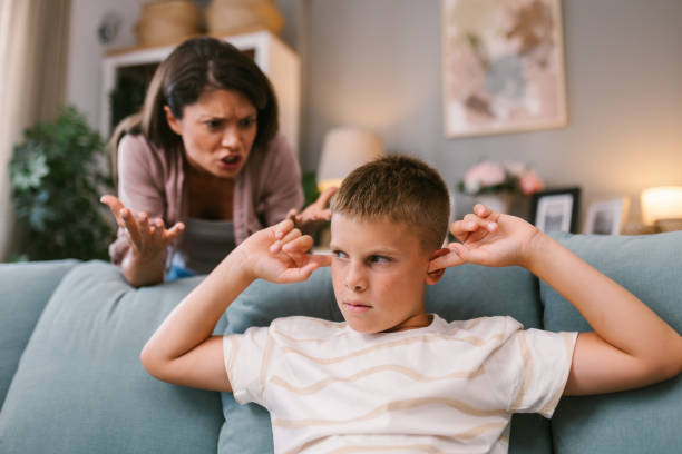 istock Mother’s Anger Grows as Son Blocks Her Out with Fingers in Ears 2171682474