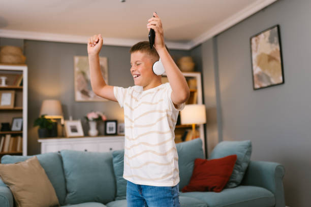 istock Young Boy Dancing with Headphones at Home 2171682643