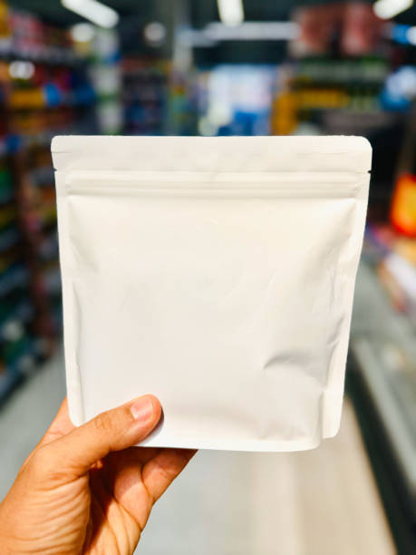 istock Hand Holding Blank White Pouch in Store Aisle 2171683613