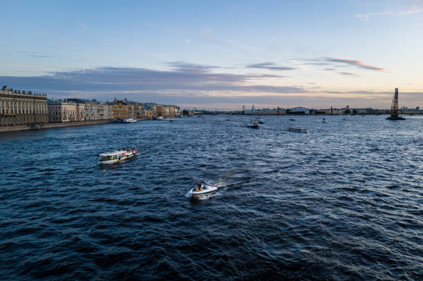 Small boats on the Neva River in St. Petersburg during the blue hour on a hot summer day