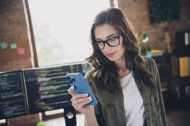 istock Photo of serious confident clever lady use telephone read proposition create new program application workstation room indoor 2171683847