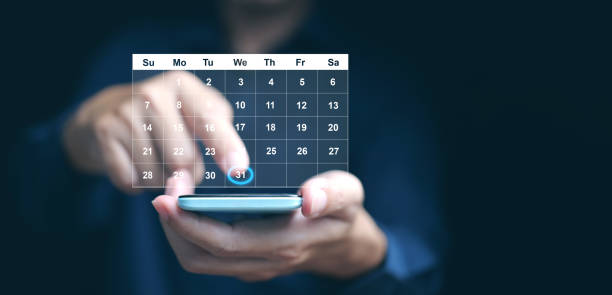 istock Planning and time management concept. A man manages his time using calendar interface on his smartphone 2171684481