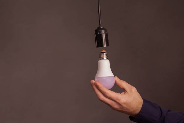 istock an LED light bulb in his hands. concept 2171686428