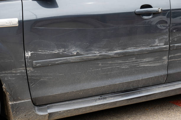 istock Dented and scratched car wheel arch bodywork. Generic car, front view, no people 2171691924