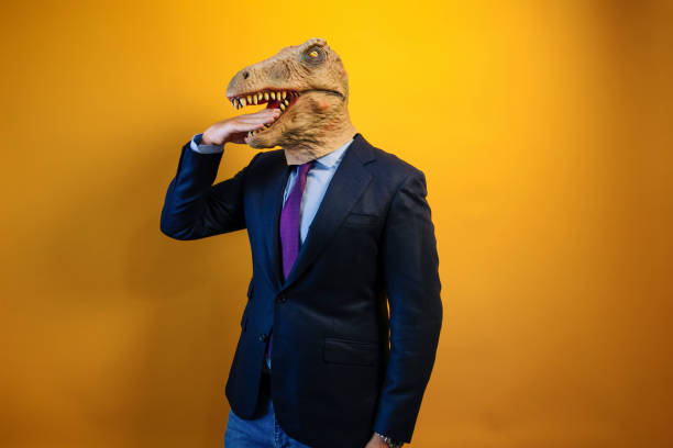 istock A man wearing a dinosaur mask bites his hand. 2171692557