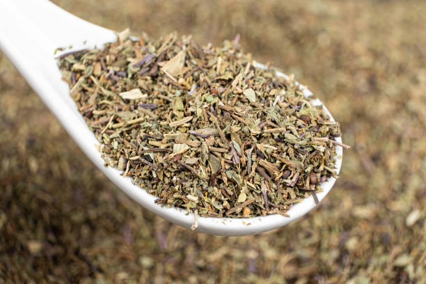 istock Spoon seasoning dry chopped basil close-up 2171699626