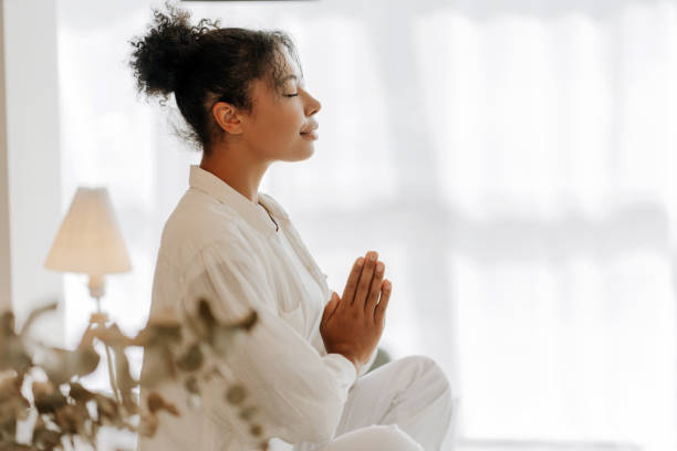istock Young woman meditating at home for inner peace and mindfulness 2171700707