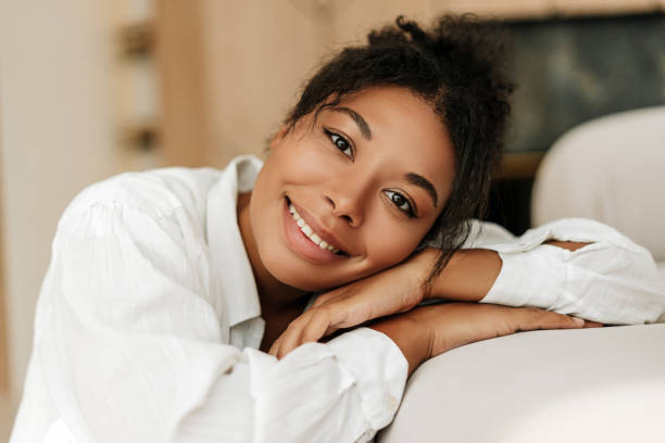 istock Beautiful woman smiling relaxing at home on sofa 2171700966