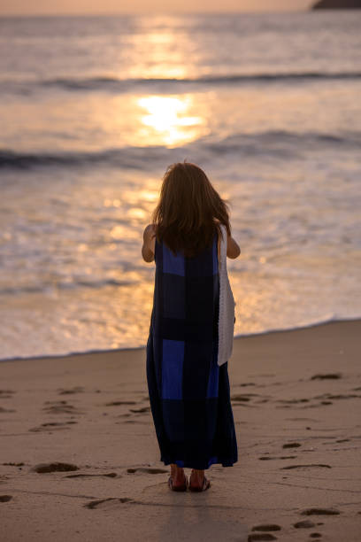 istock Breathtaking Beauty: Woman Relaxing at the Beach During Sunset 2171701221