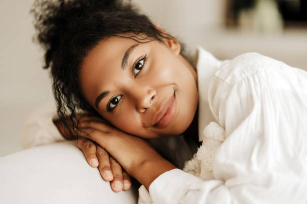 istock Young woman relaxing on sofa at home smiling 2171701309