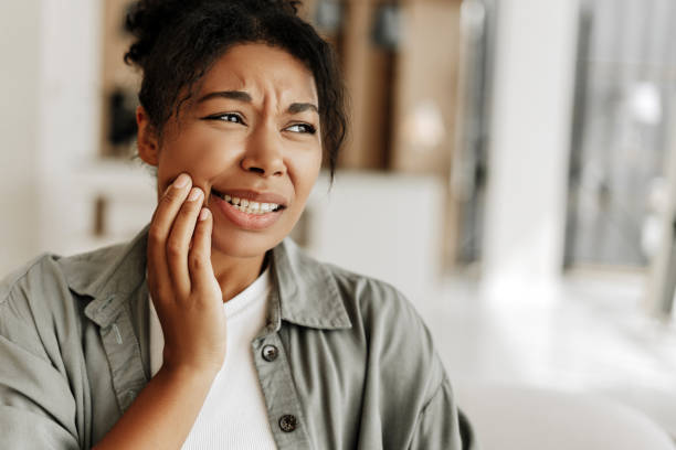 istock Young woman suffering from strong toothache at home 2171701390