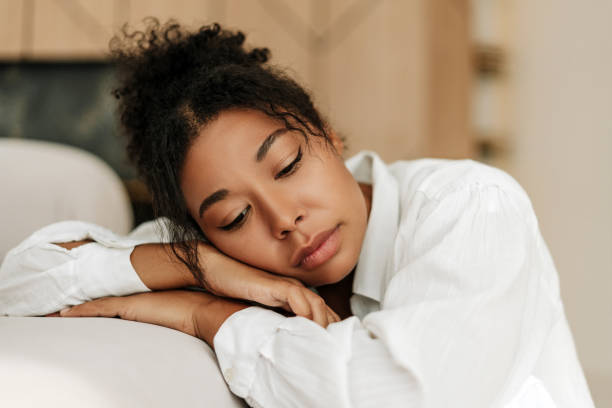 istock Young black woman feeling sad and resting head on hands 2171701409