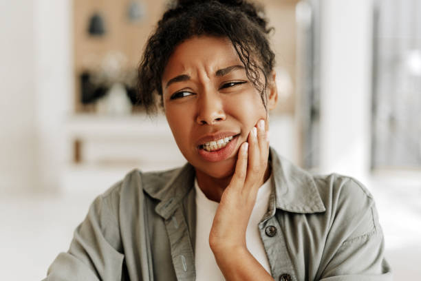 istock Young woman suffering from strong toothache at home 2171701410
