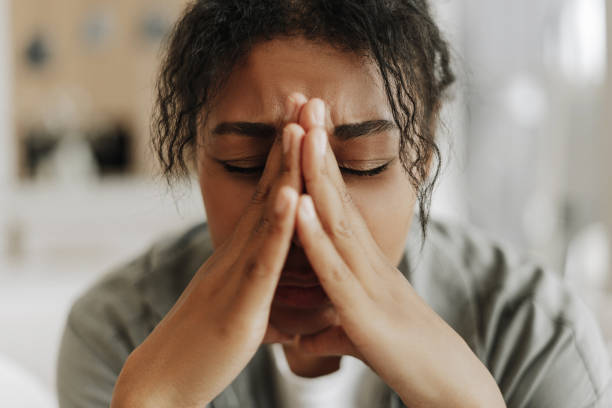 istock Young black woman suffering stress holding hands on face 2171701419