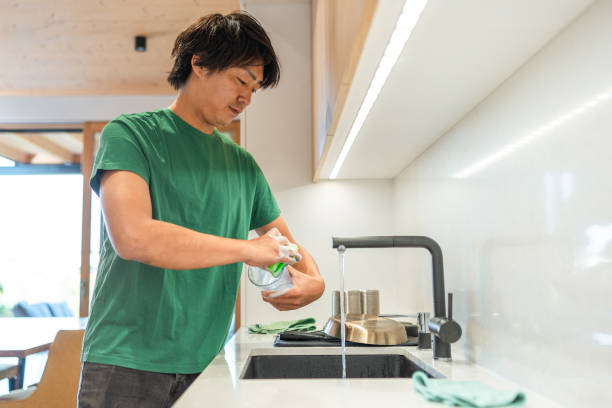 istock Asian Man Washing Dishes in Home Kitchen 2171703414