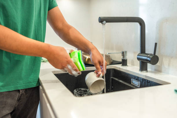istock Asian Man Washing Dishes in Kitchen 2171703415