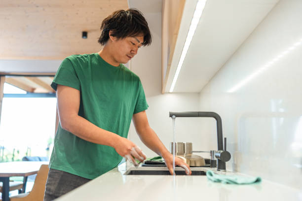 istock Asian Male Performing Kitchen Cleanup 2171703416